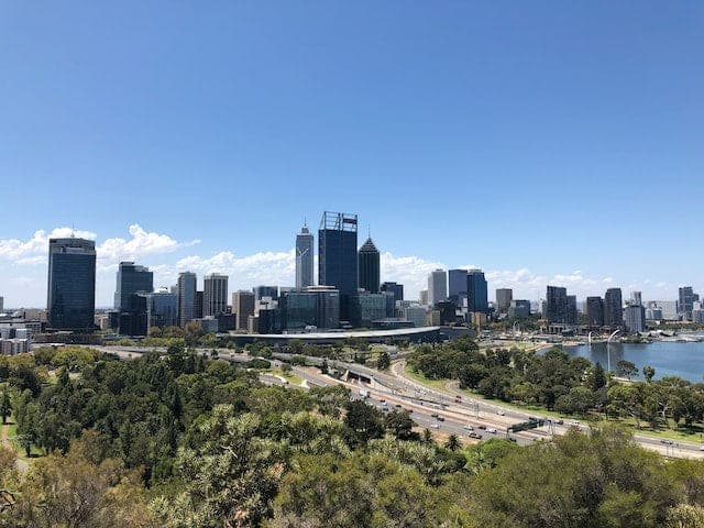 Perth's CBD skyline seen from the bushland edge of Kings Park, with the freeway and the Swan River below