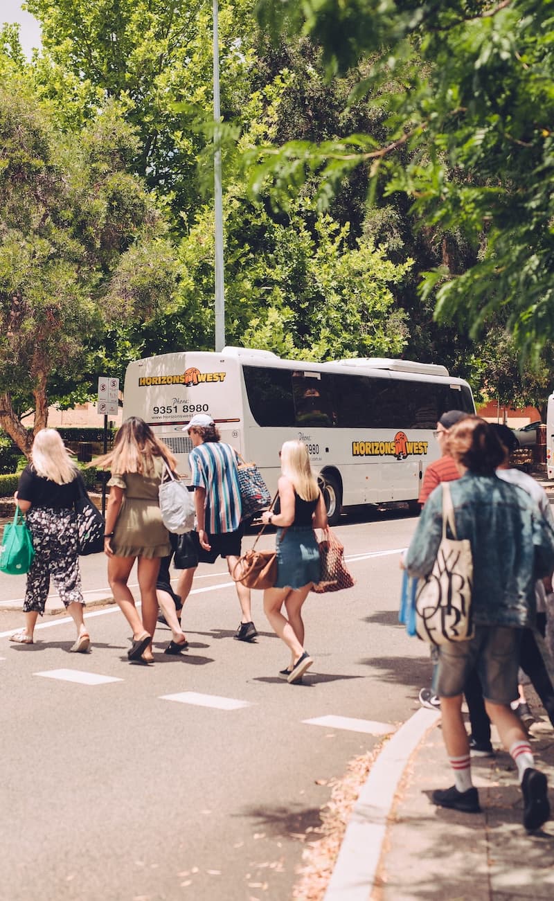 Crowd walking to a waiting Horizons West coach