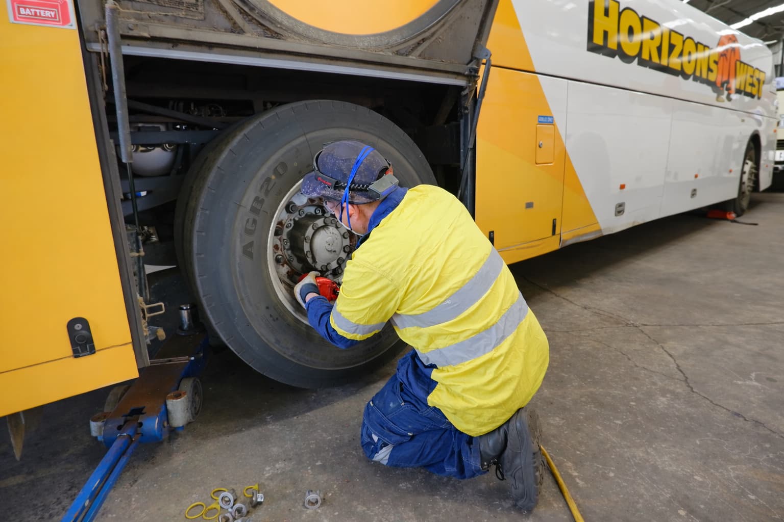 Horizons West mechanic servicing a coach wheel in the workshop