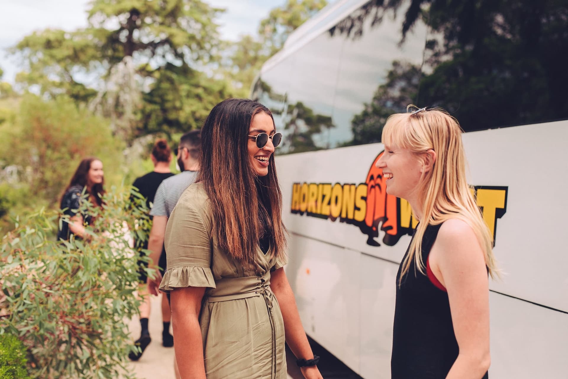 Group boarding a Horizons West coach with luggage